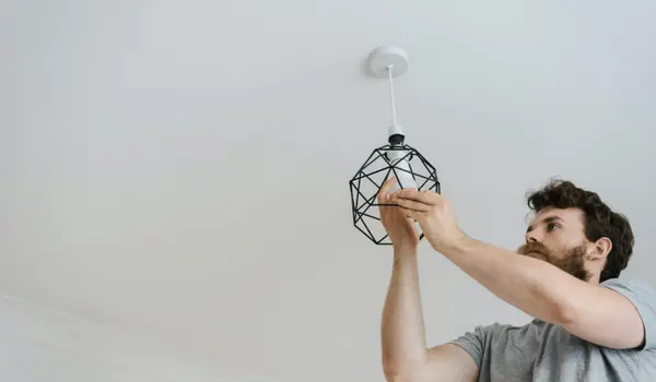 an electrician replacing a light bulb from Electrician Leander TX in Leander, TX - Electrical lighting upgrades