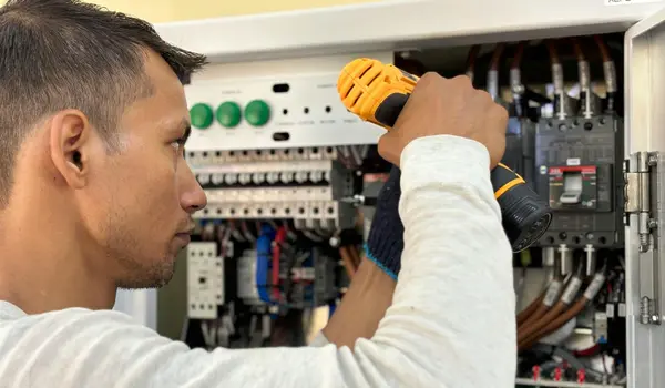 a male electrician fixing a electrical braker from Electrician Leander TX in Leander, TX - Electrician near me