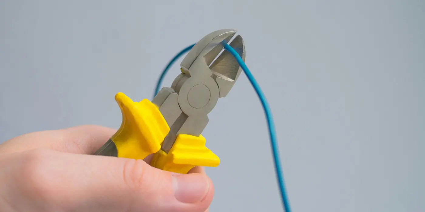a hand using a pair of pliers to cut a wire from Electrician Leander TX in Liberty Hill, TX - Liberty Hill TX